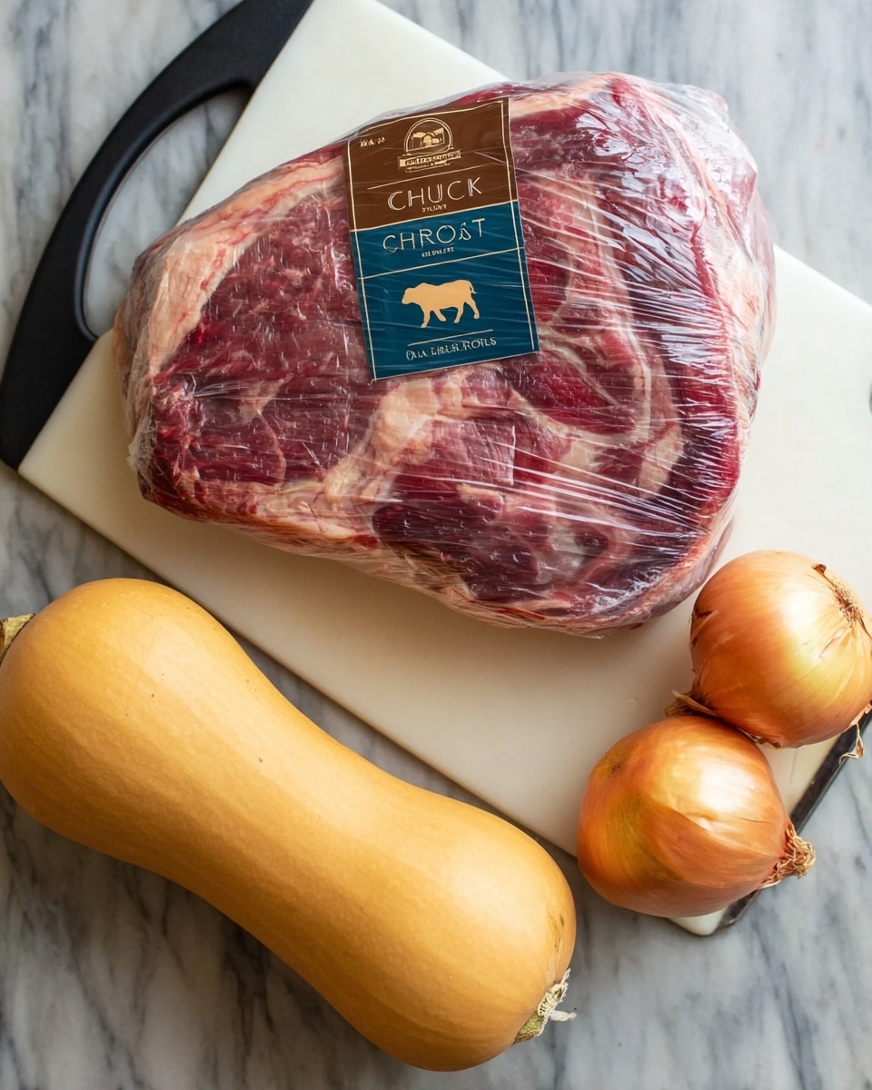 A large piece of raw chuck roast with visible red and white marbling is wrapped tightly in clear plastic and placed on a white cutting board with a black handle on a white marbled surface. To the right, there are two round yellow onions with smooth dry skins, and below them, an elongated butternut squash with a pale orange color and smooth texture. The label on the chuck roast shows a brown and blue design with a silhouette of a cow and the words