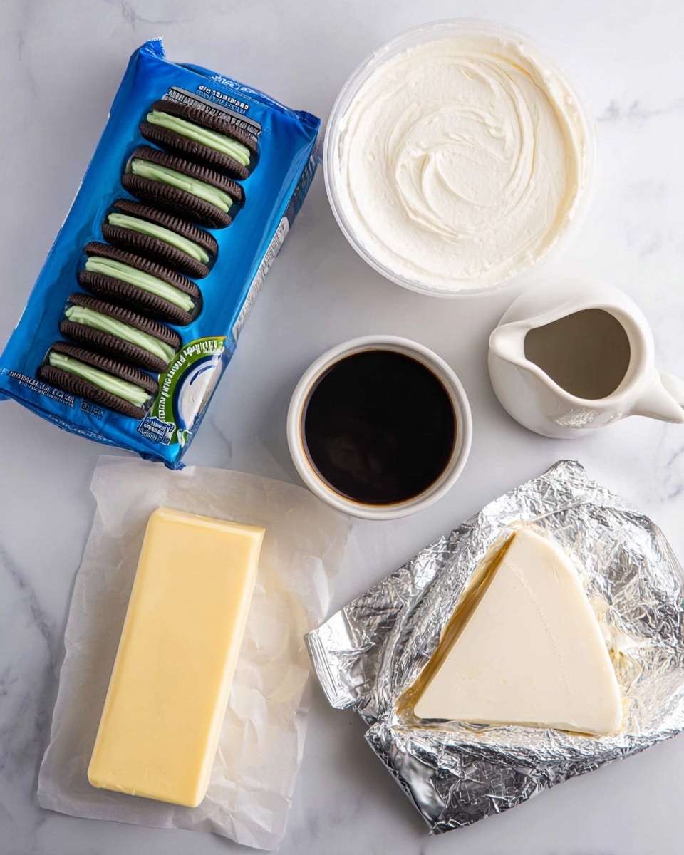 The image shows several baking ingredients placed on a white marbled surface. On the left side, there is an open blue pack of sandwich cookies with dark brown outer layers and green cream inside lined up in three rows. Moving right, there is a small white cup filled with dark liquid, a rectangular stick of butter in a slightly opened yellow wrapper, and a white jug with a creamy liquid inside it. Above these, there is a white open container full of thick, white cream and next to it on the top right, a small white pitcher filled with a dark sauce. On the bottom right, an opened silver foil packet reveals a triangular wedge of smooth, light cream cheese. All items are neatly arranged and clearly visible, photo taken with an iphone --ar 4:5 --v 7