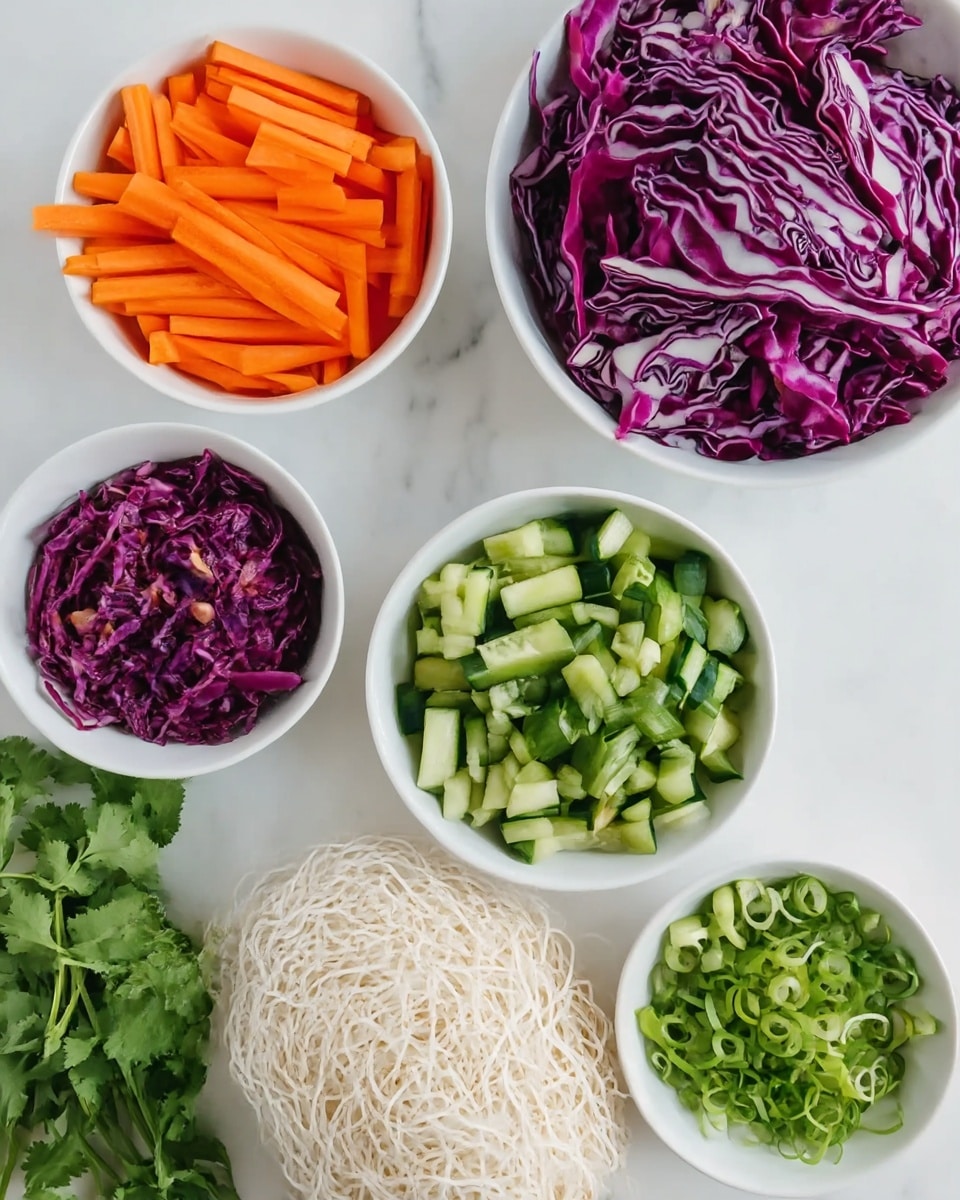 The image shows several white bowls and dishes arranged on a white marbled surface. One bowl contains bright orange carrot sticks arranged in short strips, another bowl holds thinly sliced purple cabbage with white veins, and a third bowl is filled with chopped green cucumbers. There is a small white bowl full of whole shelled peanuts and another with finely sliced green onions. In the center, there is a pile of uncooked thin white noodles. Fresh green cilantro sprigs are placed beside the bowls, adding a touch of leafy green. The overall look is colorful, fresh, and neatly arranged. photo taken with an iphone --ar 4:5 --v 7
